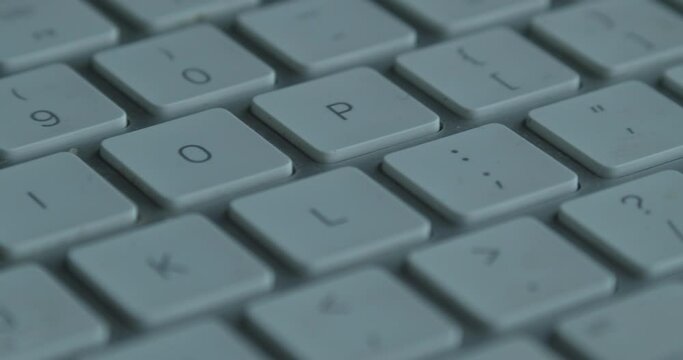 Slider view along dim white keys on computer keyboard, macro
