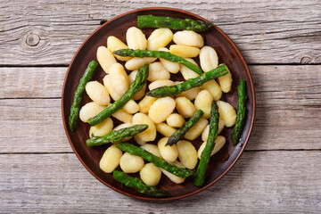 Italian homemade potatoes gnocchi with asparagus