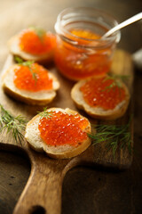 Red caviar on toast with fresh dill