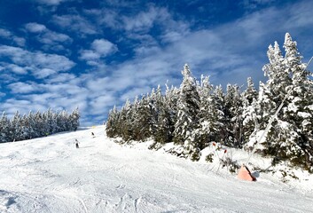 Beautiful sunny snow day with blue sky and clouds at the Stowe Mountain Ski resort Vermont -...