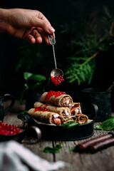 pancakes with red caviar fish and cream cheese on a wooden background