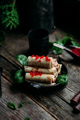 pancakes with red caviar fish and cream cheese on a wooden background