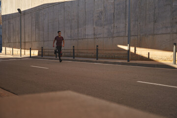Man running through the city in the sunlight