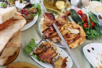 Dish with roasted young pig and vegetable salad. Food table background.