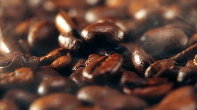 Freshly roasted coffee beans with smoke.