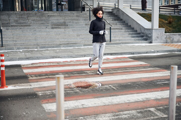 Jogging person is going through a crossing