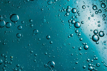 oil drops on water on blue background