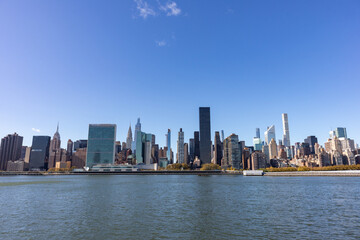 Fototapeta na wymiar Midtown Manhattan Skyline along the East River with a Clear Blue Sky in New York City