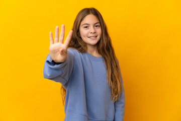 Child over isolated yellow background happy and counting four with fingers