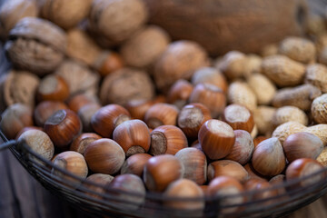 still life with hazelnut peanuts walnut and coconut on wooden board