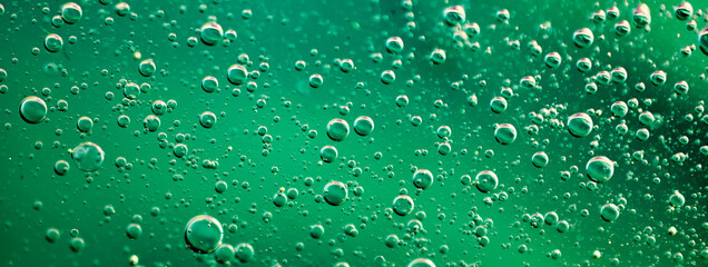 oil drops on water on green background