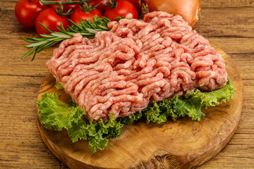 Raw pork minced meat over board
