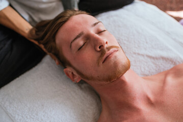 Fototapeta na wymiar Man Receiving Relaxing Head Massage