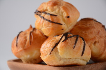 Eclair drenched in chocolate stuffed with white crème