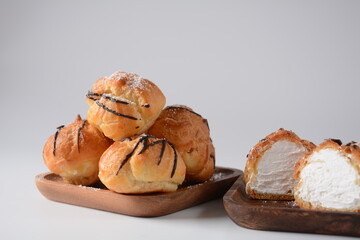 Eclair drenched in chocolate stuffed with white crème