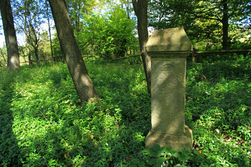 Old stone grave in cemetery of Jasiel - former and abandoned village in Low Beskids, Poland