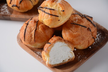 Eclair drenched in chocolate stuffed with white crème