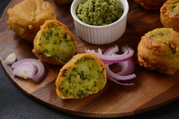 Batata vada  popular street food of India, Served with  green chutney.