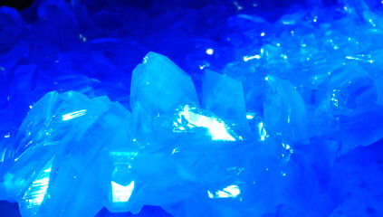Macrophotography of blue transparent crystals of copper sulfate. Crystal surface texture.