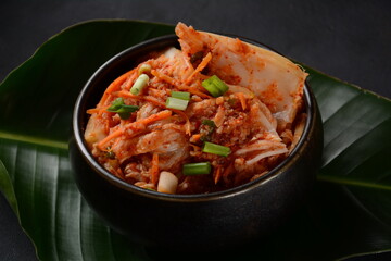 Kimchi in black bowl. Traditional Korean food