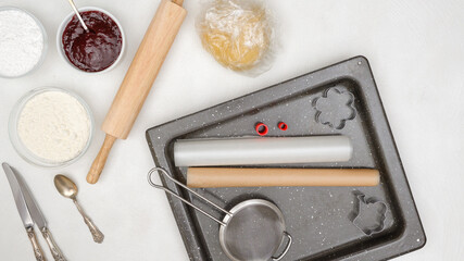 Cookies baking process. Ingredients and tools close up on kitchen table, flat lay