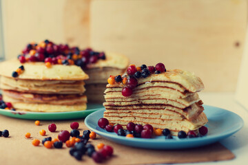 Breakfast Thin pancakes with frozen berries and honey