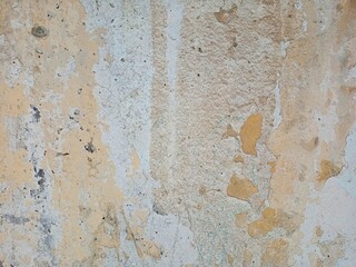 The old concrete wall is painted with paints.