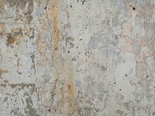 The old concrete wall is painted with paints.