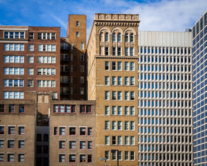 Fototapeta premium Cityscape of Modern and Brick Buildings. Concept of Crowded Urbanity. Copy Space for Architectural Design.