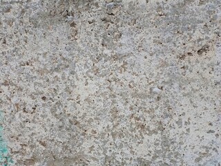 The old concrete wall is painted with paints.