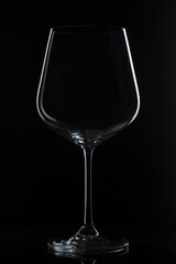 Glass goblet on a black background. Utensils for wine.