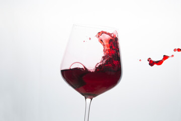 Red wine in a glass on a white background.
