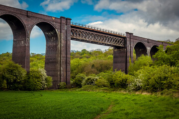 Fototapeta na wymiar A view of the girder span of the Conisbrough Viaduct over the River Don at Conisbrough, Yorkshire, UK in springtime