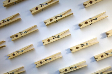 Wooden clothes pegs on white background. Top view.