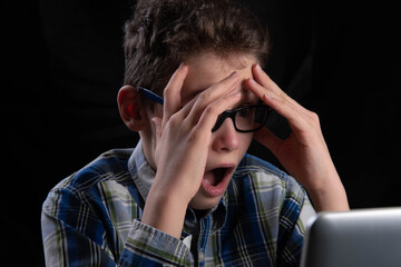Student ruffles hair on computer is amazed