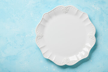 Empty plate on blue background