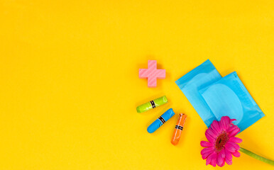 Woman hygienic protection, menstruation, cotton swabs, sanitary pads on a yellow background. critical days. Copy space.