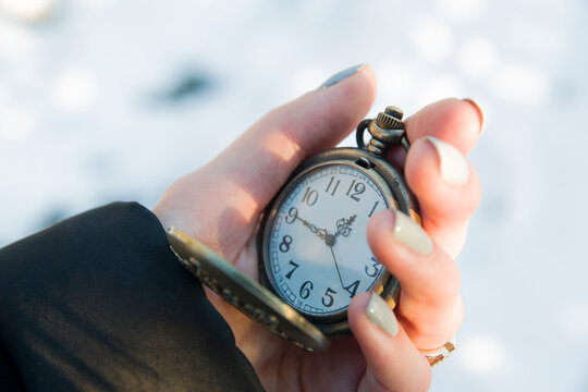 Old antique metallic pocket opened watch. time 12:45, noon hour. Watch arrows, passing time, life, deadline