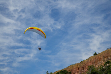 Paragliding with a Motorizes Parachute near some cliffs by a beach