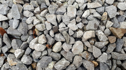 Natural stone pebble material texture background. stone background, dark gravel pebbles stone