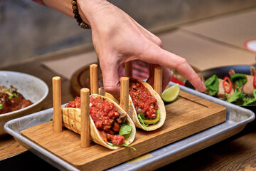 Traditional street mexican pork tacos with beef, tomatoes, avocado, chilli in yellow corn tortilla
