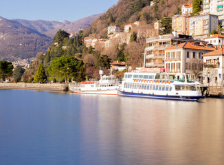bright landscape of Como lakefront in a mild and sunny winter day.Como lake, lombardy, italian lakes, Italy.