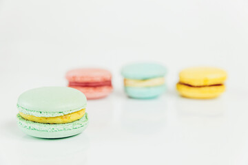 Sweet almond colorful pastel pink blue yellow green macaron or macaroon dessert cake isolated on white background. French sweet cookie. Minimal food bakery concept Copy space