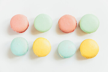 Sweet almond colorful pastel pink blue yellow green macaron or macaroon dessert cake isolated on white background. French sweet cookie. Minimal food bakery concept. Flat lay top view, copy space