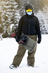 Fototapeta na wymiar Young girl snowboarder holding her snowboard