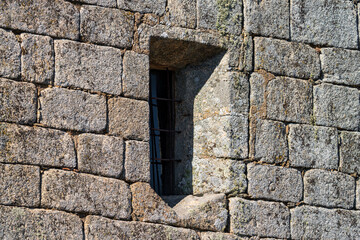 Window deep into the stone wall facade
