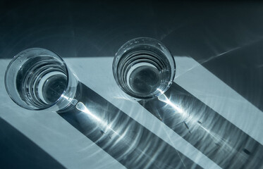 Two glasses of water. Shadow from glasses