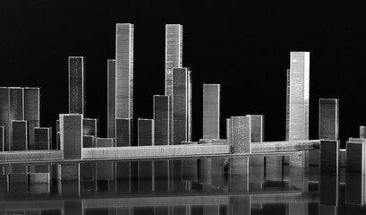 Panorama de bâtiments et paysage urbain sur fond noir en agrafes en métal avec éclairage de nuit et reflets. Projet d'architecture, construction, développement, concept urbain, immobilier, affaires.	