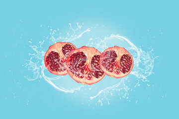 Pomegranate slices with water splash isolated on blue blackground.
