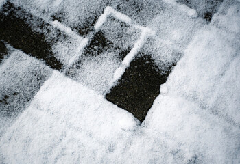 concrete paving partly covered with snow